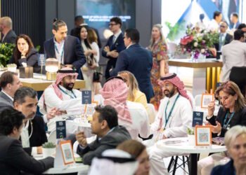 Aviation and hospitality executives networking at a major exhibition in Dubai.