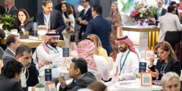 Aviation and hospitality executives networking at a major exhibition in Dubai.