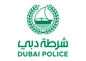 Dubai Police logo and security personnel at Dubai International Airport transit terminal