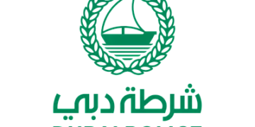 Dubai Police logo and security personnel at Dubai International Airport transit terminal