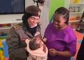 Ruth Waithera and her infant receiving assistance at the GDRFA Center for Harboring in Al Aweer, Dubai.