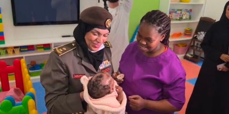 Ruth Waithera and her infant receiving assistance at the GDRFA Center for Harboring in Al Aweer, Dubai.