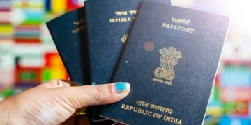 Indian expatriates submitting passport and visa application documents at an outsourcing service center in the UAE.