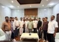 Exterior view of the Ras Al Khaimah government municipal logo and Indian Association community leaders during the development meeting.