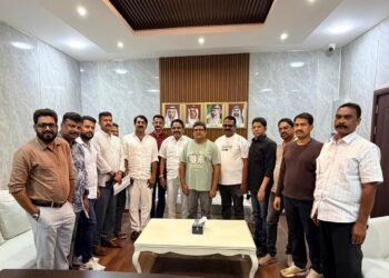 Exterior view of the Ras Al Khaimah government municipal logo and Indian Association community leaders during the development meeting.
