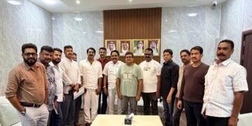 Exterior view of the Ras Al Khaimah government municipal logo and Indian Association community leaders during the development meeting.