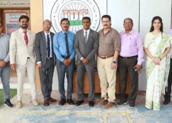 Consul General Satish Kumar Sivan handing over RAK crematorium site plan to Indian Relief Committee leaders.