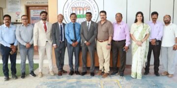 Consul General Satish Kumar Sivan handing over RAK crematorium site plan to Indian Relief Committee leaders.