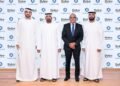 Passengers shopping at Dubai Duty Free counter with digital payment options available