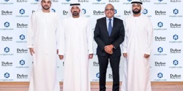 Passengers shopping at Dubai Duty Free counter with digital payment options available