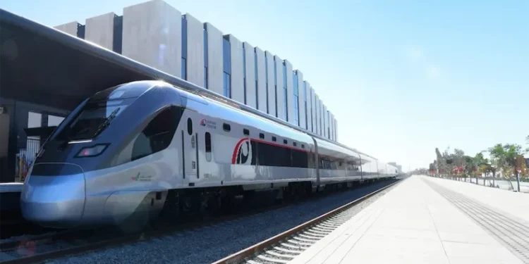 Etihad Rail passenger train traveling on the track in the UAE
