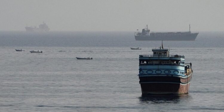 Commercial cargo vessel navigating near the Strait of Hormuz maritime passage.