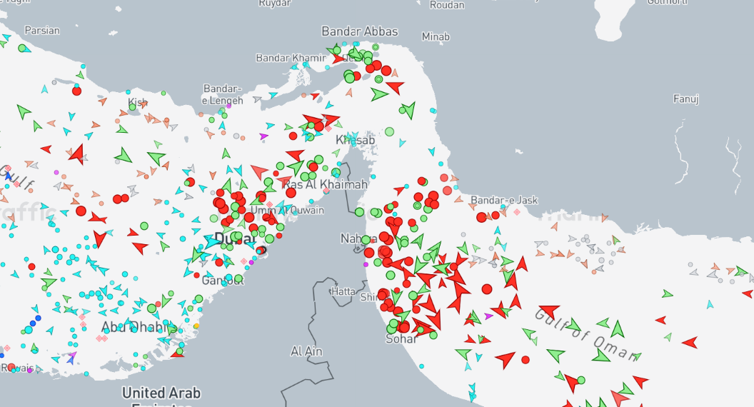 Satellite and maritime AIS traffic map showing shipping lanes in the Strait of Hormuz near Oman.