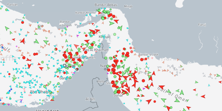 Satellite and maritime AIS traffic map showing shipping lanes in the Strait of Hormuz near Oman.