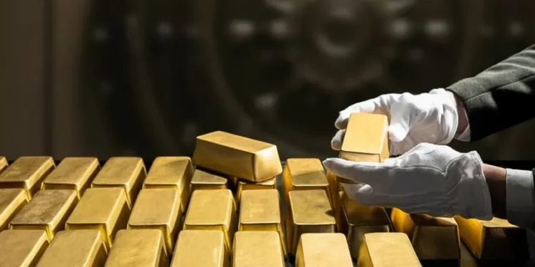 Gold bars and coins displayed in a Dubai gold souk window.