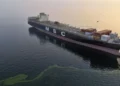Large oil tanker navigating narrow maritime passage in the Strait of Hormuz
