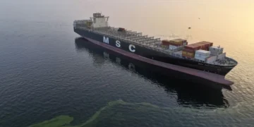 Large oil tanker navigating narrow maritime passage in the Strait of Hormuz