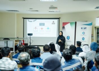 Abu Dhabi Civil Defence officers instructing industrial workers on hazardous materials handling and safety equipment.