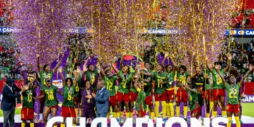 Cameroon women's national football team celebrating with the WAFCON trophy in Rabat.