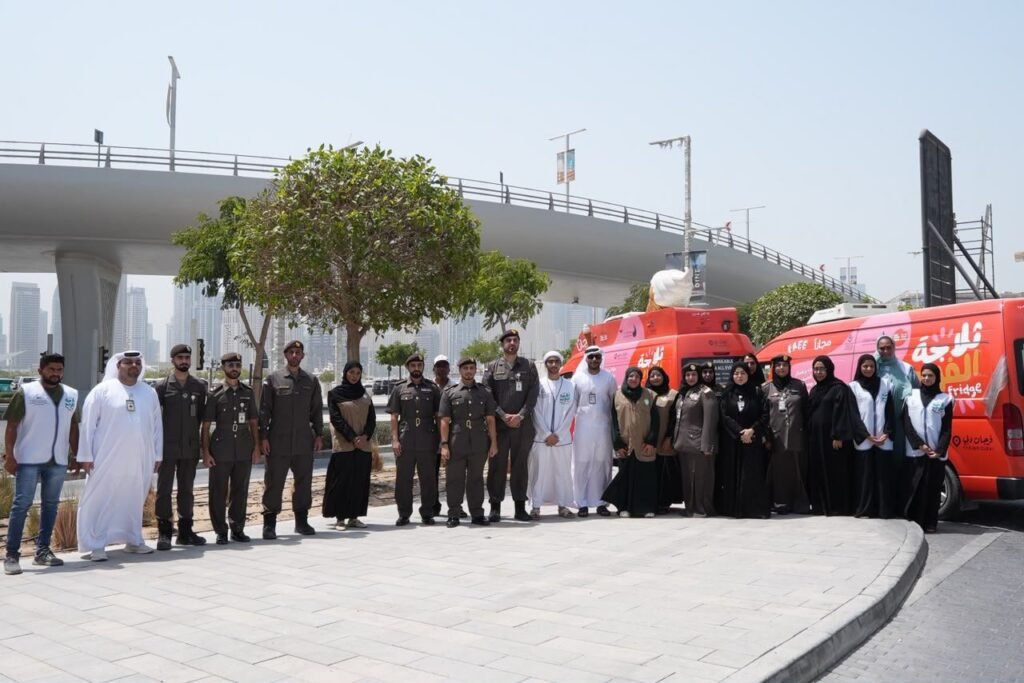GDRFA officers distributing cold drinking water and refreshments to outdoor workers in Dubai during summer.