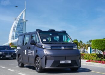 Baidu Apollo Go autonomous Robotaxi driving on a street in Dubai, UAE