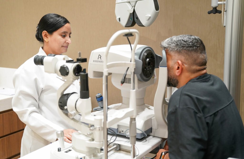 Optometrist conducting a digital eye test for a driving licence applicant in Dubai.