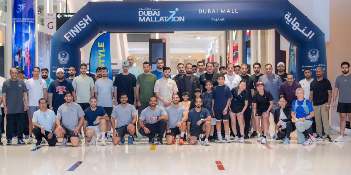 GDRFA Dubai immigration officers participating in the Dubai Mallathon indoor walking initiative at a local shopping mall.