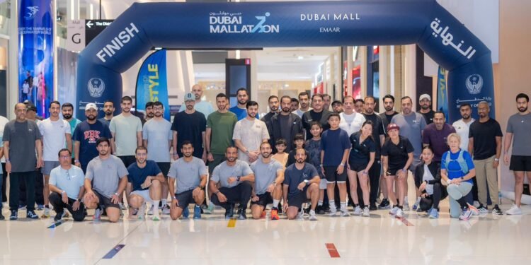 GDRFA Dubai immigration officers participating in the Dubai Mallathon indoor walking initiative at a local shopping mall.