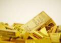 Gold prices fell to a two-week low of $4,417.04 per ounce on Monday following hawkish signals from Fed Chair Kevin Warsh regarding U.S. interest rates.