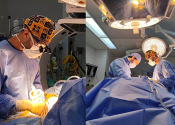 Spine surgeon evaluating 3D-printed custom surgical guide for scoliosis correction procedure in Dubai hospital