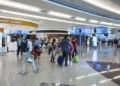 Passengers waiting at Dubai International Airport terminal amid flight cancellations and delays