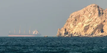 Container ships navigating maritime trade routes in the Gulf region.