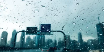 Dark rain clouds over mountainous terrain in the UAE during a summer convective shower