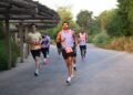Runners taking part in an outdoor community event with Sharjah Safari nature reserve in the background