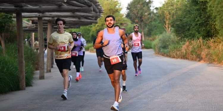 Runners taking part in an outdoor community event with Sharjah Safari nature reserve in the background