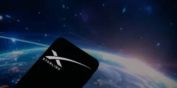 Starlink satellite dish antenna positioned outdoors against a clear city skyline