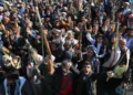 Houthi militia supporters brandish weapons as they rally in Sanaa, Yemen, on October 9, 2026.