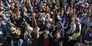 Houthi militia supporters brandish weapons as they rally in Sanaa, Yemen, on October 9, 2026.